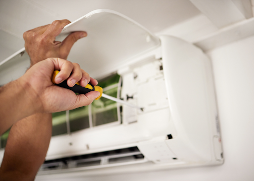 AC repair technician in action